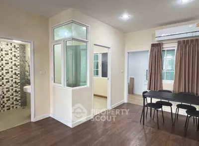 Spacious modern living area with stylish flooring and ample natural light, perfect for comfortable living.