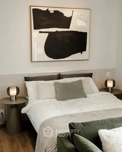 Stylish bedroom with modern decor and cozy bedding in a contemporary apartment.