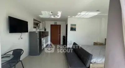 Modern studio apartment with sleek kitchen and cozy living area, perfect for urban living.