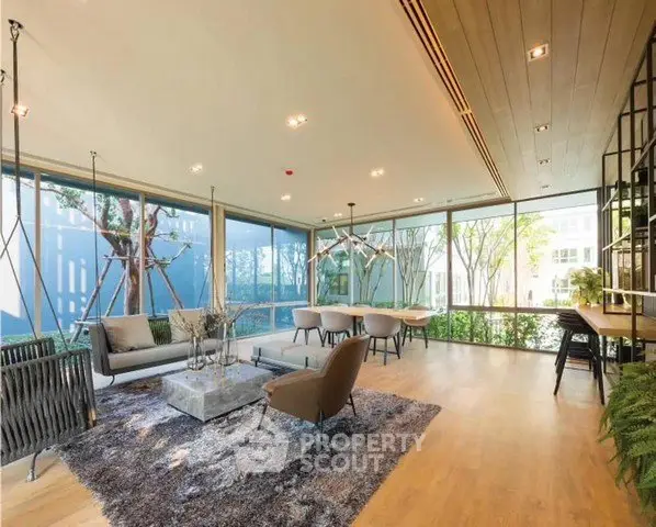 Spacious modern living room with floor-to-ceiling windows and stylish decor