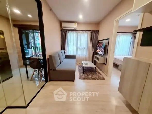 Modern living room with sleek design and cozy ambiance in a stylish apartment.