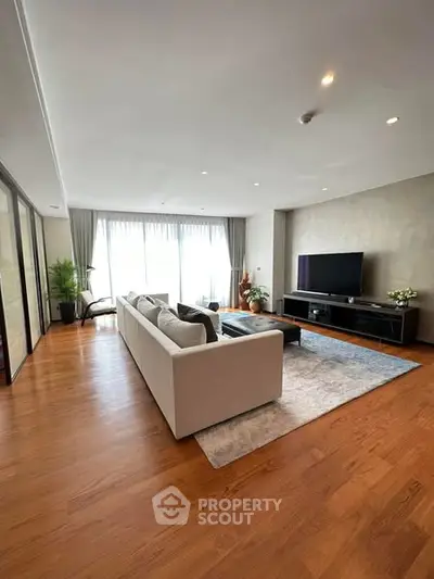 Spacious modern living room with elegant decor and large windows