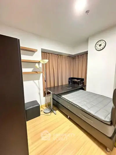 Cozy bedroom with modern furnishings and natural light, ideal for comfortable living.