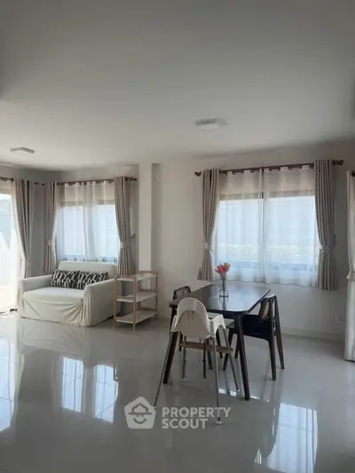 Spacious living room with modern furniture and large windows for natural light.