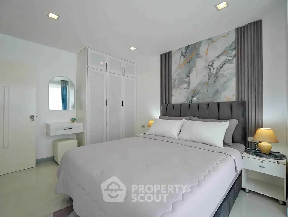 Modern bedroom with elegant decor and ample storage space