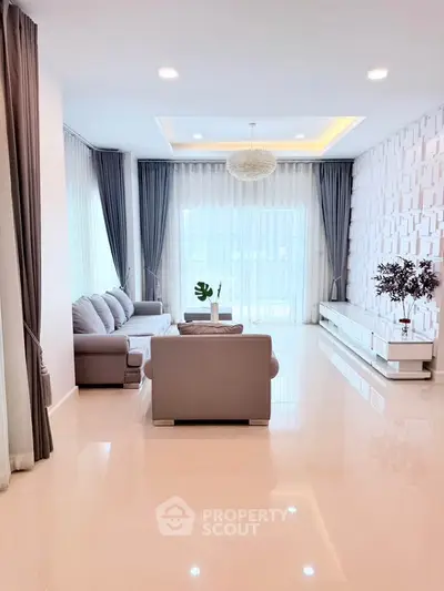 Spacious modern living room with elegant decor and large windows for natural light.