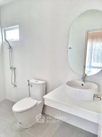 Modern minimalist bathroom with sleek fixtures and large mirror