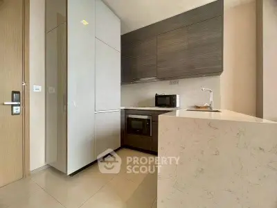Modern kitchen with sleek cabinetry and built-in appliances in a stylish apartment.