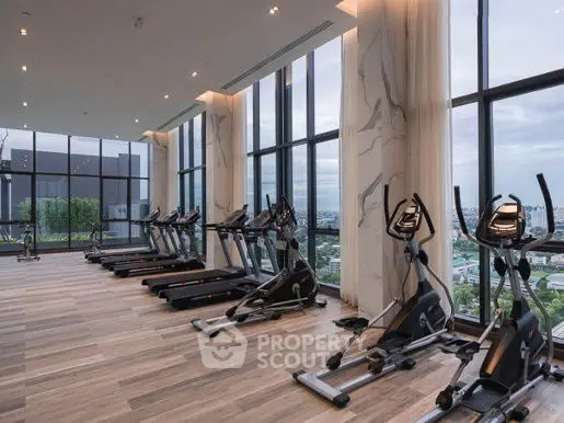 Luxurious high-rise gym with panoramic city views and modern equipment.