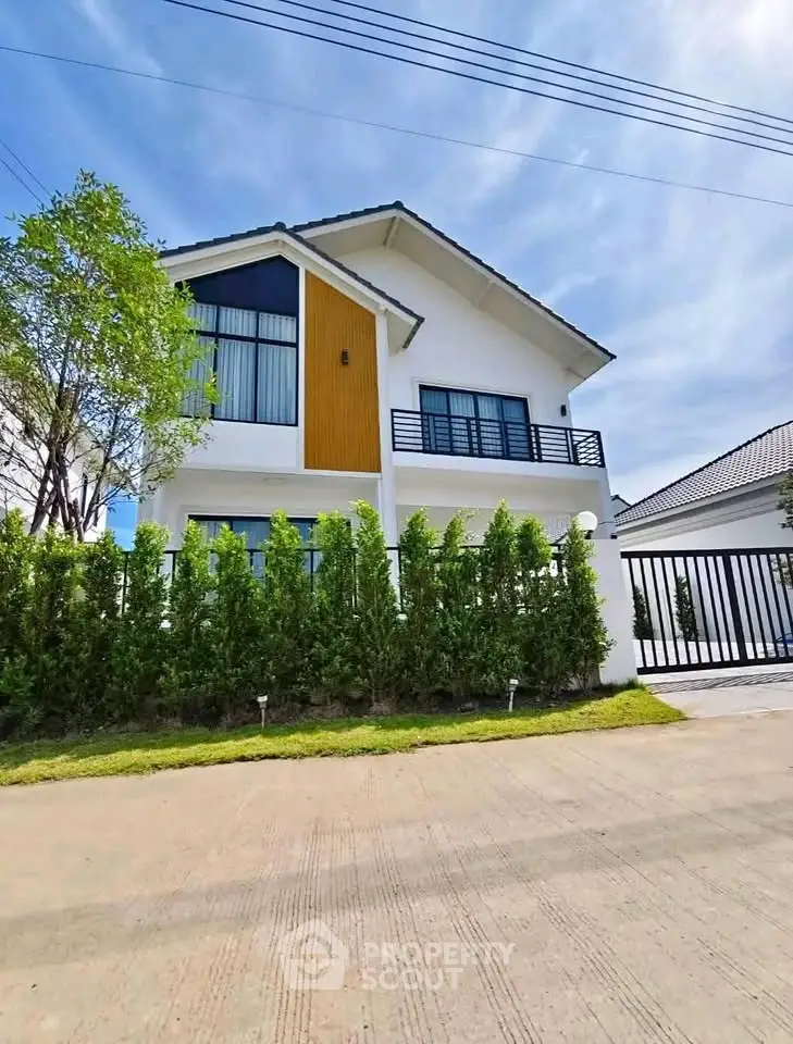 Modern two-story house with large windows and a stylish facade