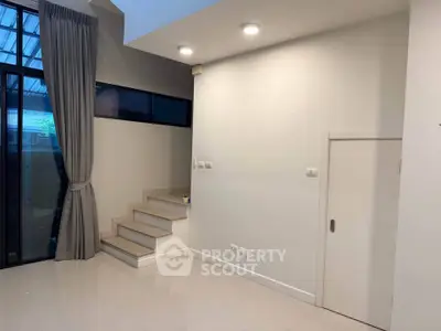 Modern interior with high ceiling and staircase in a stylish home