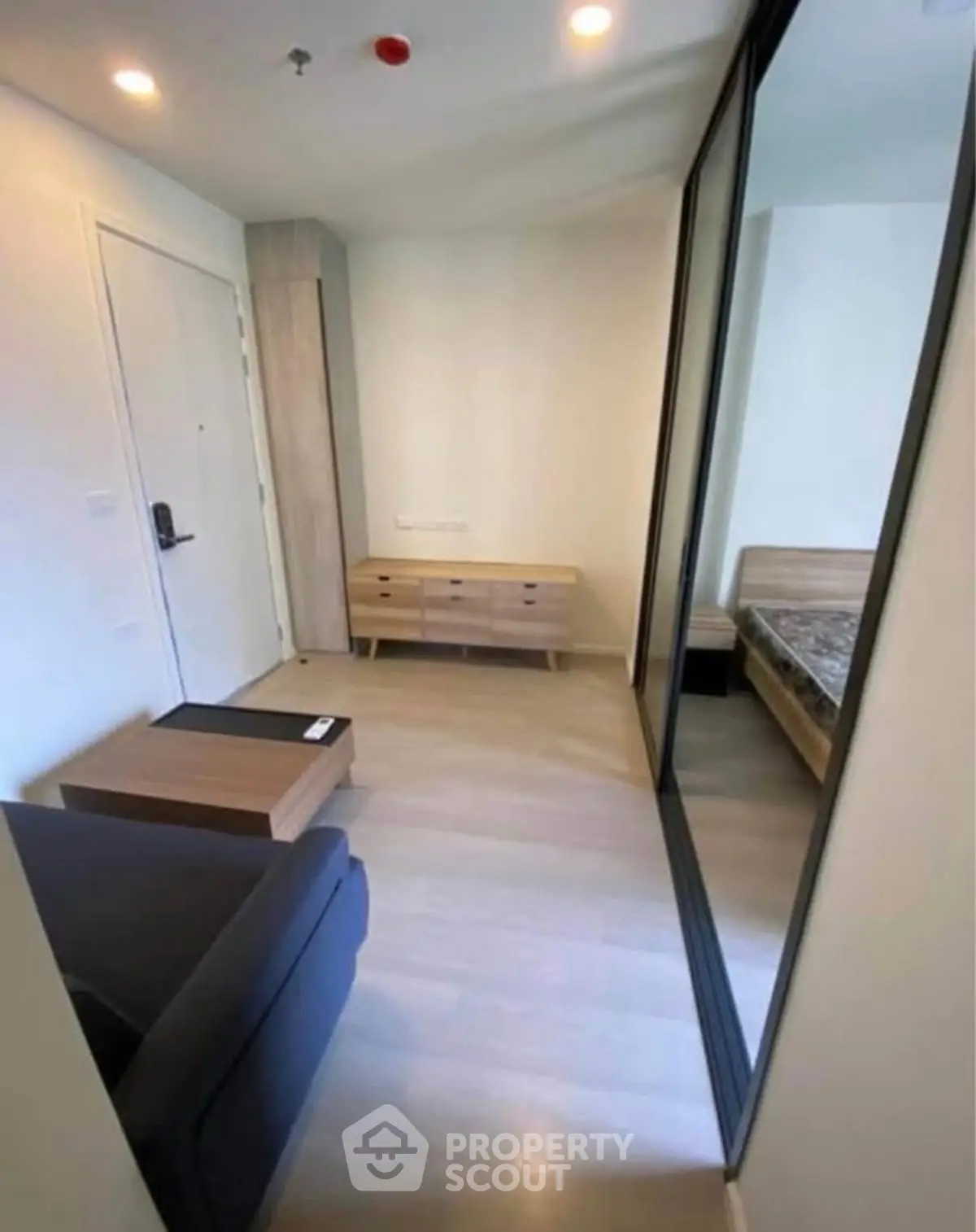 Modern apartment interior with sleek furniture and mirrored wardrobe