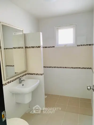 Bright and modern bathroom with sleek fixtures and neutral tiles