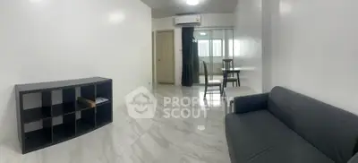 Spacious modern living room with sleek marble flooring and minimalist furniture.