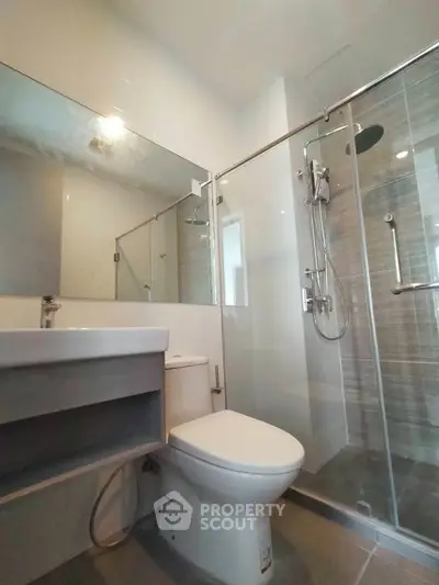 Modern bathroom with glass shower and sleek fixtures