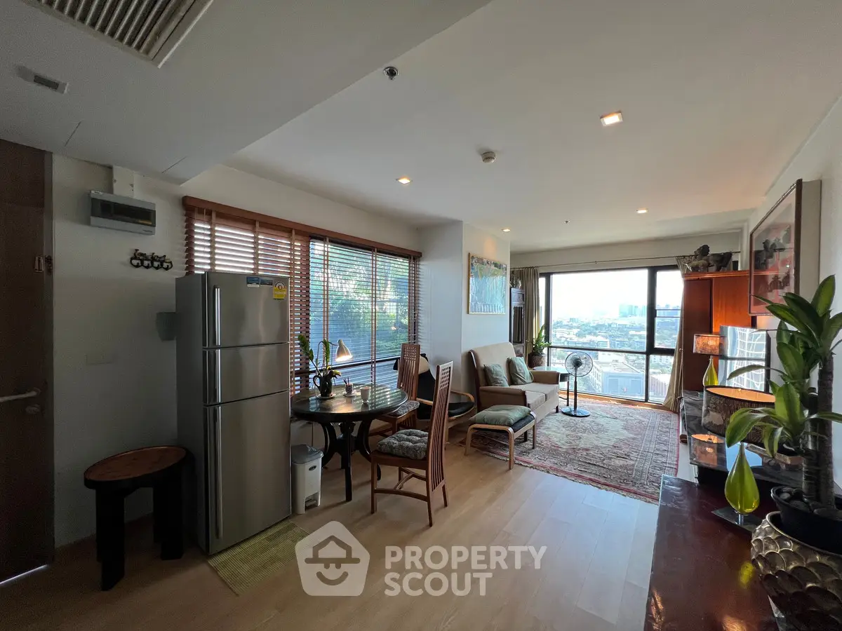 Spacious living room with dining area and city view, featuring modern decor and natural light.