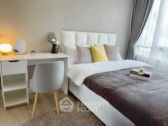 Modern bedroom with stylish decor, cozy bed, and natural light from large window.