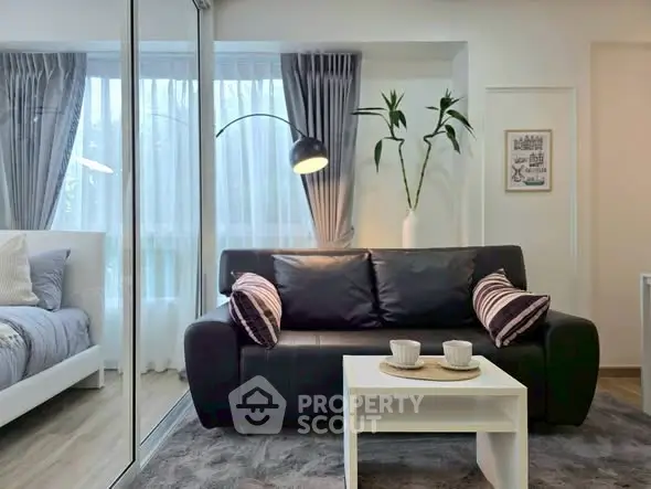 Modern living room with sleek black sofa and stylish decor