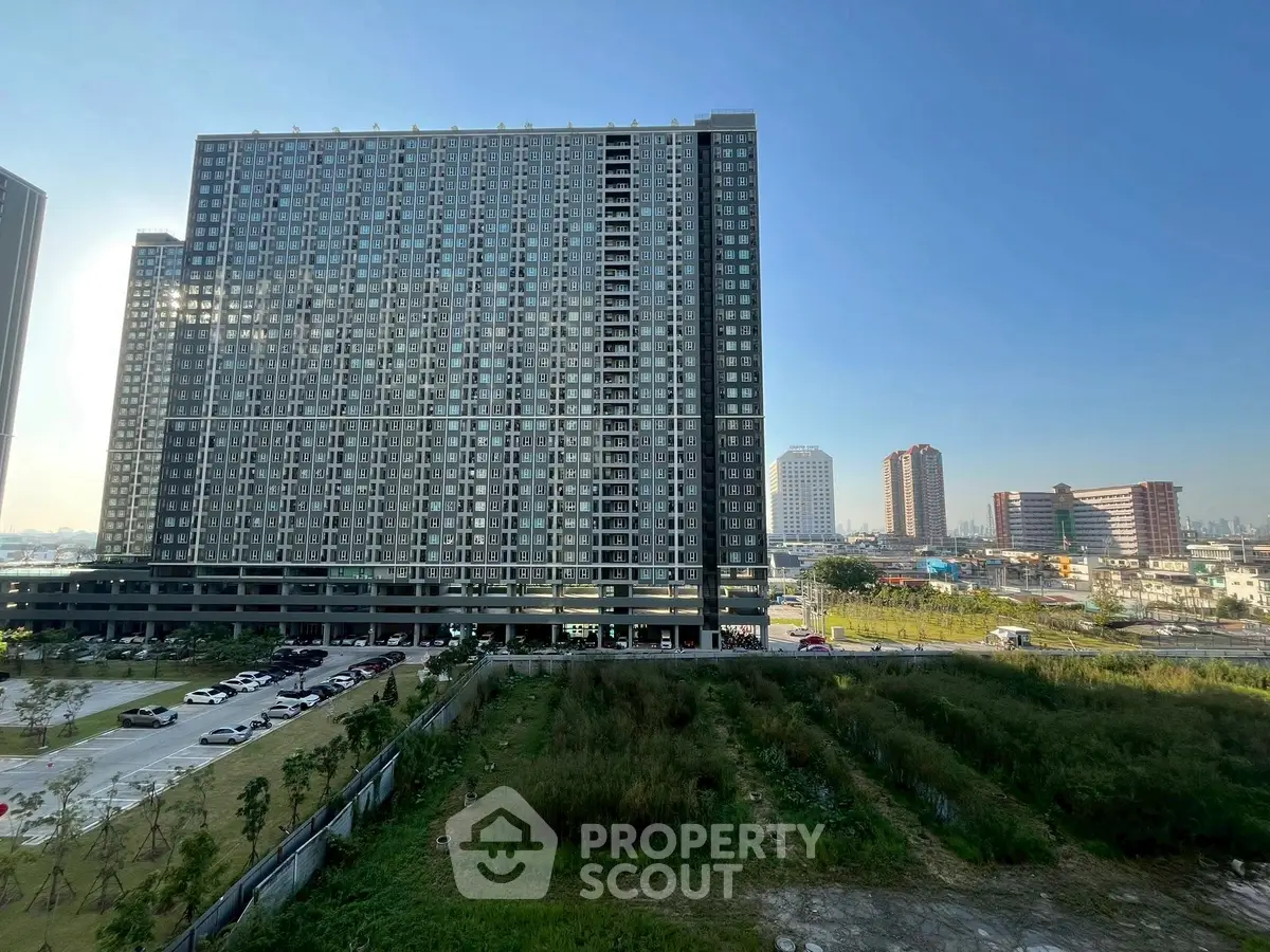 Modern high-rise residential building with urban skyline view