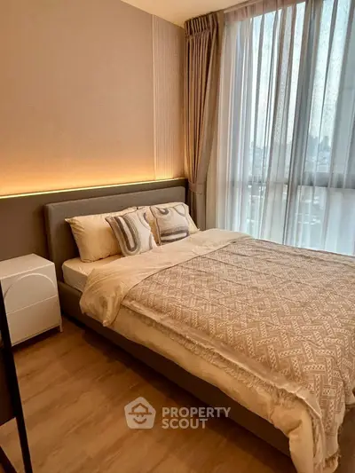 Cozy modern bedroom with stylish decor and large window view