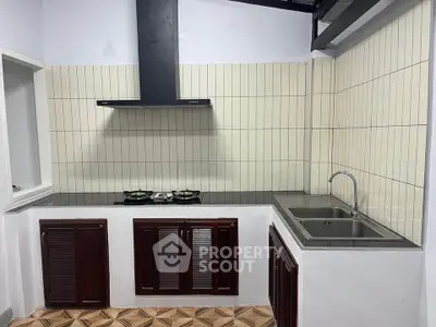 Modern kitchen with gas stove and sleek cabinetry, perfect for culinary enthusiasts.