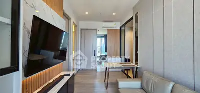 Modern living room with sleek design, wall-mounted TV, and stylish furniture in a contemporary apartment.