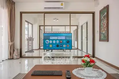 Spacious modern living room with large TV and elegant decor