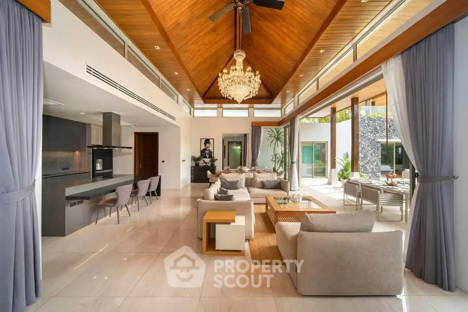 Luxurious open-plan living room with high ceilings and elegant chandelier in modern villa