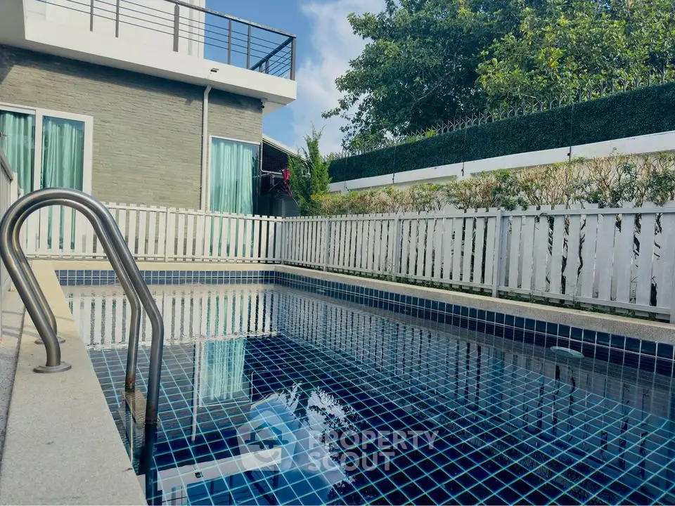 Luxurious modern home with private swimming pool and stylish exterior design.