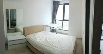 Bright bedroom with large window and modern furnishings