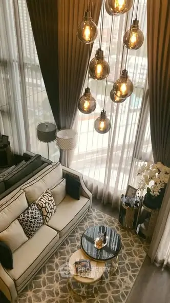 Luxurious high-ceiling living room with elegant lighting and modern decor