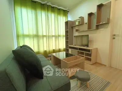 Cozy living room with modern furniture and green curtains, perfect for relaxation.