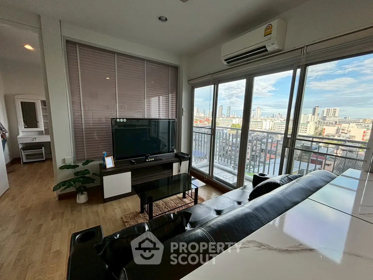 Modern living room with city view and balcony access in urban apartment