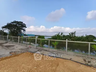 Scenic view of construction site with lush greenery and water body