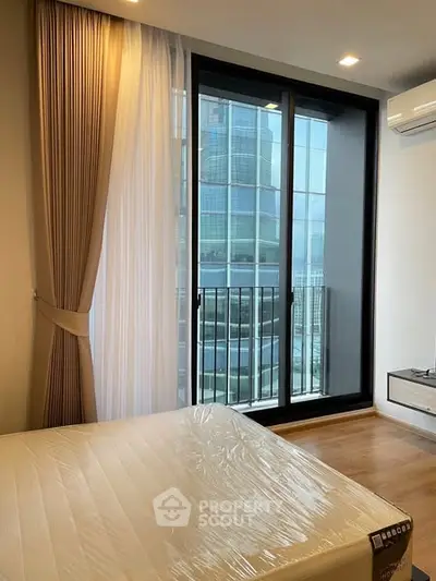 Modern bedroom with floor-to-ceiling windows and city view