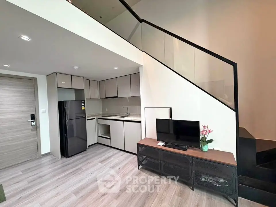Modern duplex apartment with sleek kitchen and stylish staircase