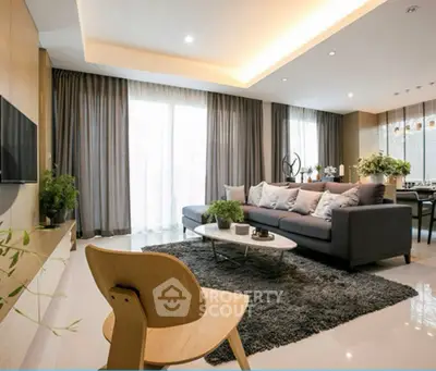 Modern living room with cozy sofa, stylish decor, and large windows for natural light.