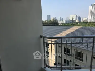 Cozy balcony with city view, perfect for relaxation and enjoying the skyline.