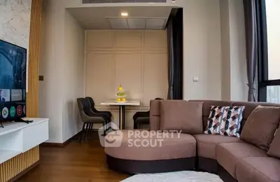Modern living room with stylish furniture and large windows offering natural light.