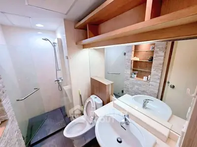 Modern bathroom with glass shower and stylish fixtures in a contemporary apartment.