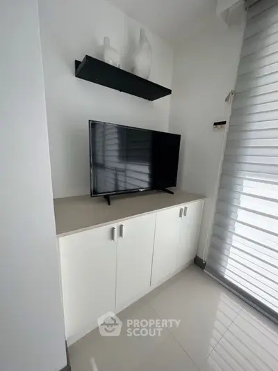 Modern living room corner with sleek TV setup and stylish decor