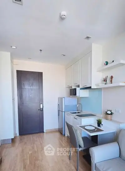 Modern compact kitchen with sleek design and integrated dining area