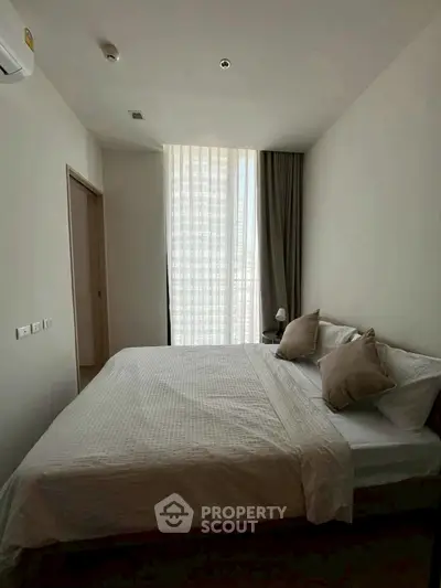 Cozy bedroom with soft lighting and modern decor in a stylish apartment.