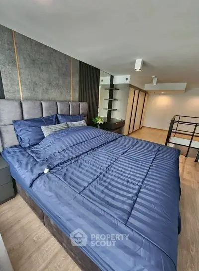 Luxurious bedroom with modern design and plush bedding in a stylish apartment.
