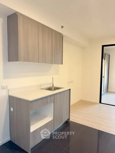 Modern kitchen with sleek cabinets and open layout in bright apartment