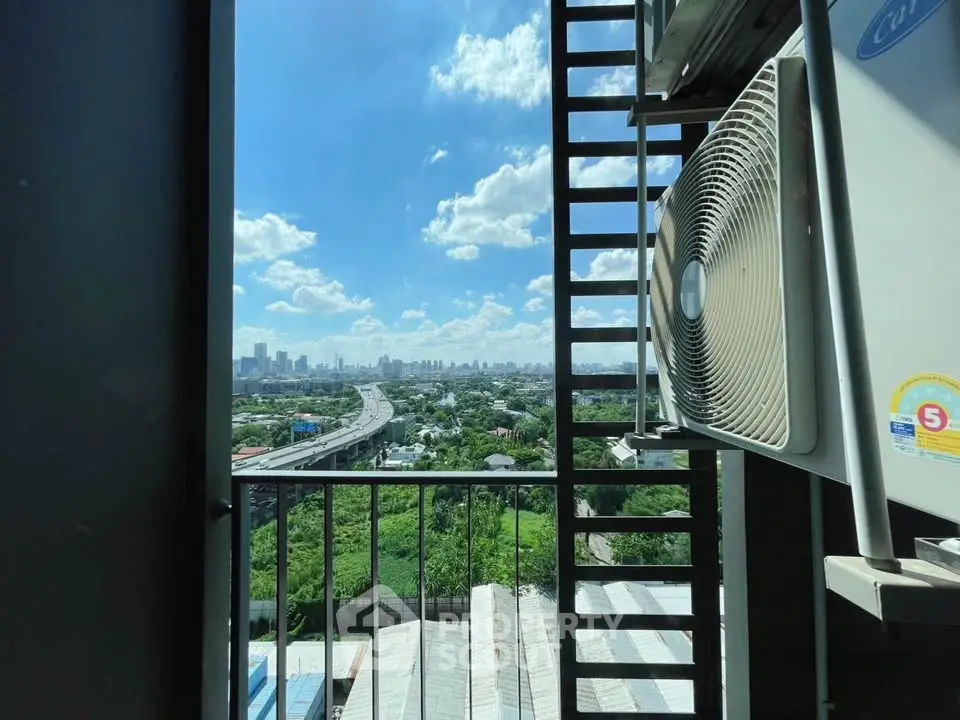 Stunning cityscape view from a high-rise balcony with air conditioning unit.
