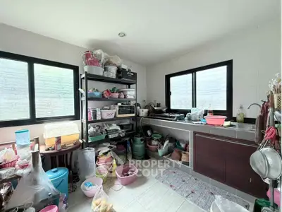 Spacious kitchen with ample storage and natural light, featuring modern appliances and organized shelving.