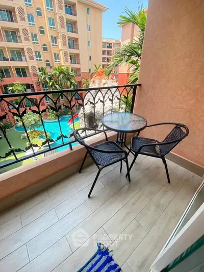 Charming balcony with pool view in a modern apartment complex