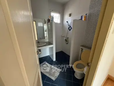 Cozy bathroom with modern blue tile flooring and white fixtures