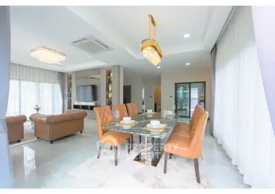Luxurious open-plan living and dining area with elegant decor and modern furnishings.